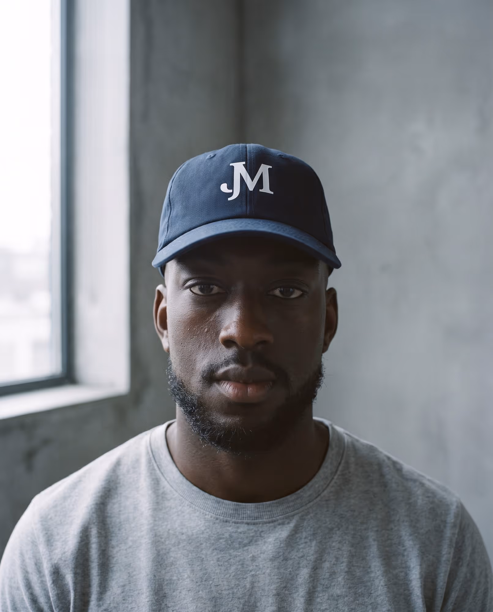 Navy cap with two interlocking white letters printed on the front panel