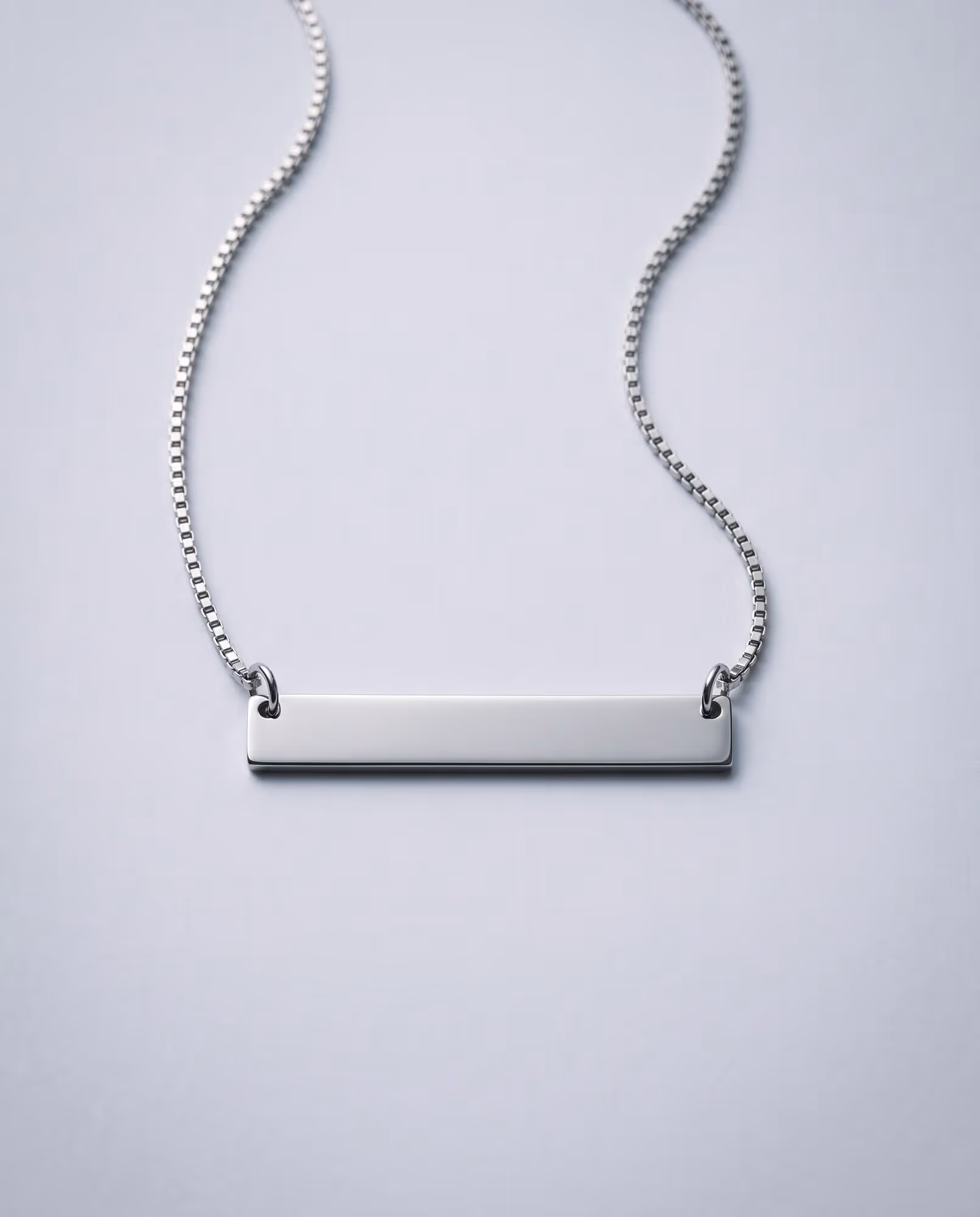 Blank polished silver-tone bar pendant on a silver-tone box chain