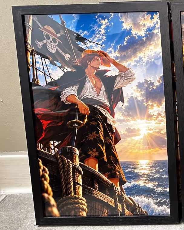 Black wooden frame holding an anime-style poster of a red-haired pirate captain on a ship's deck at sunset