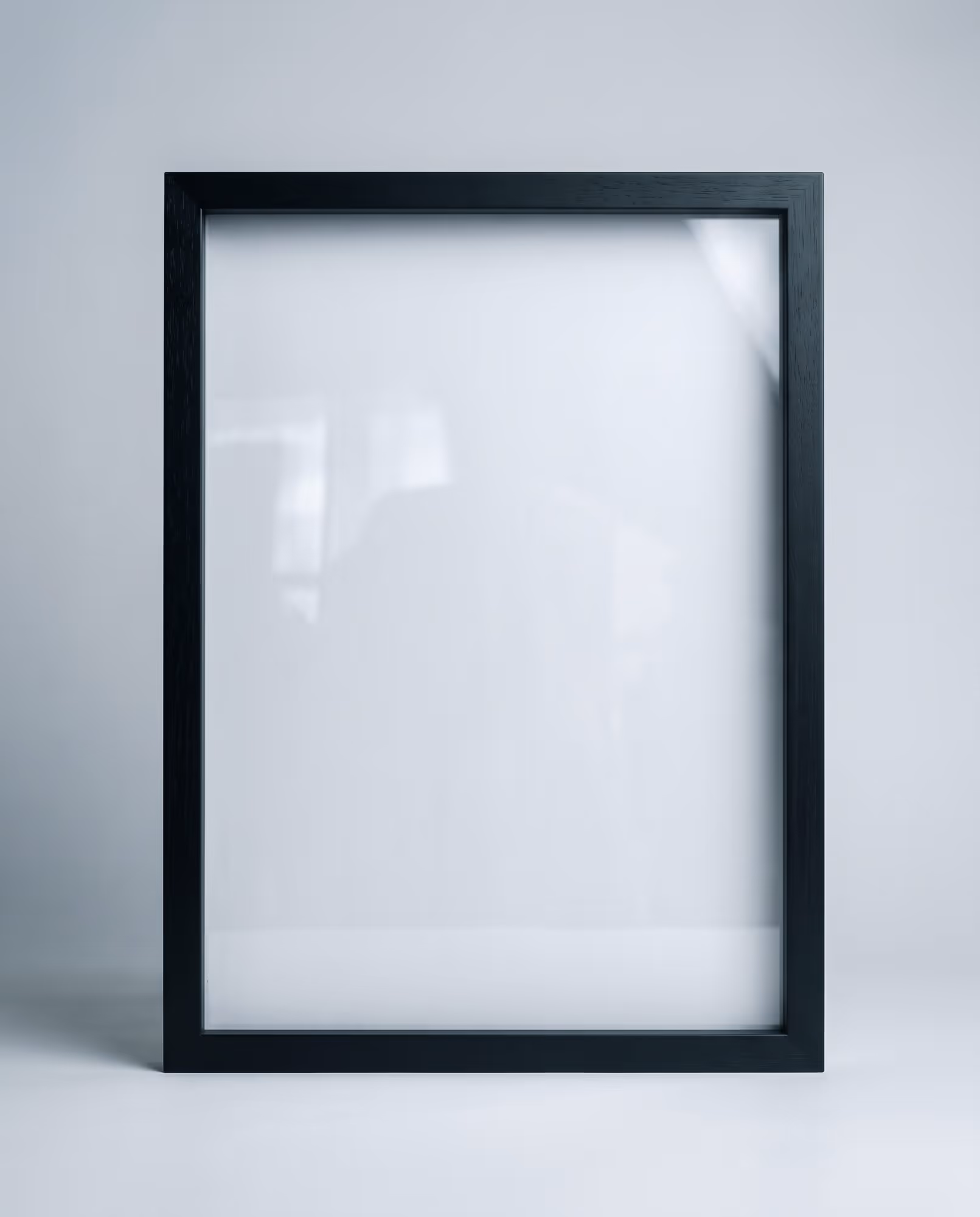 Empty black wooden 11 by 17 inch portrait frame standing upright, front view