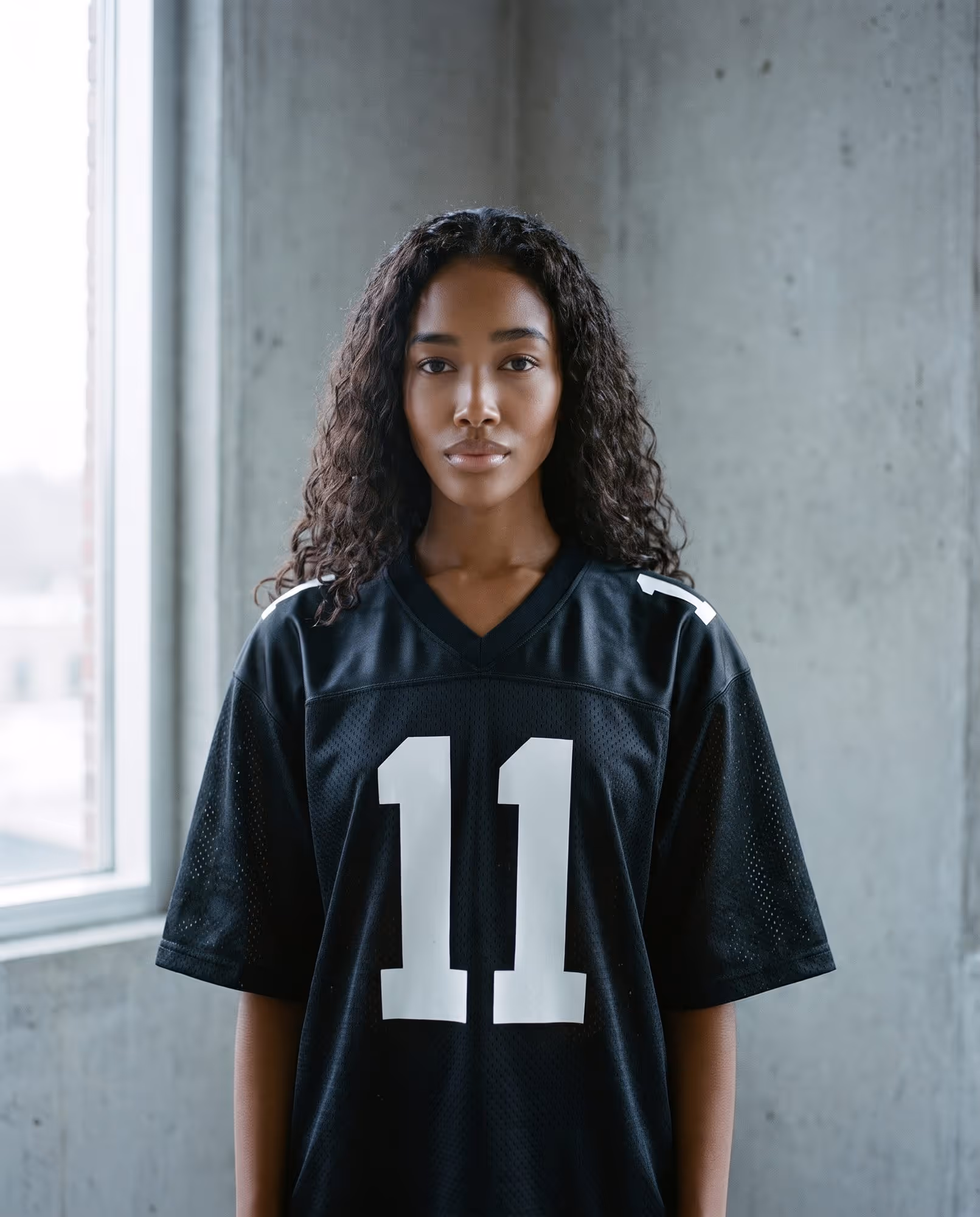 Black jersey with a large white number 11 on the chest and small matching numbers on the shoulders