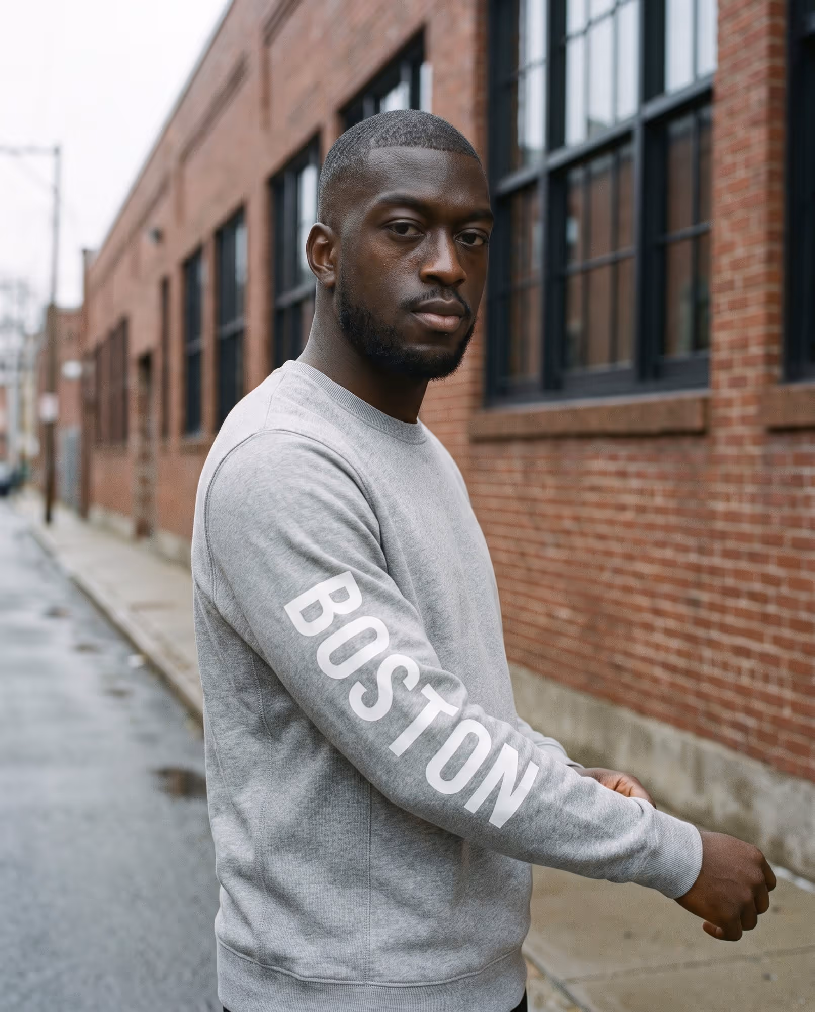 Heather grey crewneck sweatshirt with BOSTON printed down the sleeve