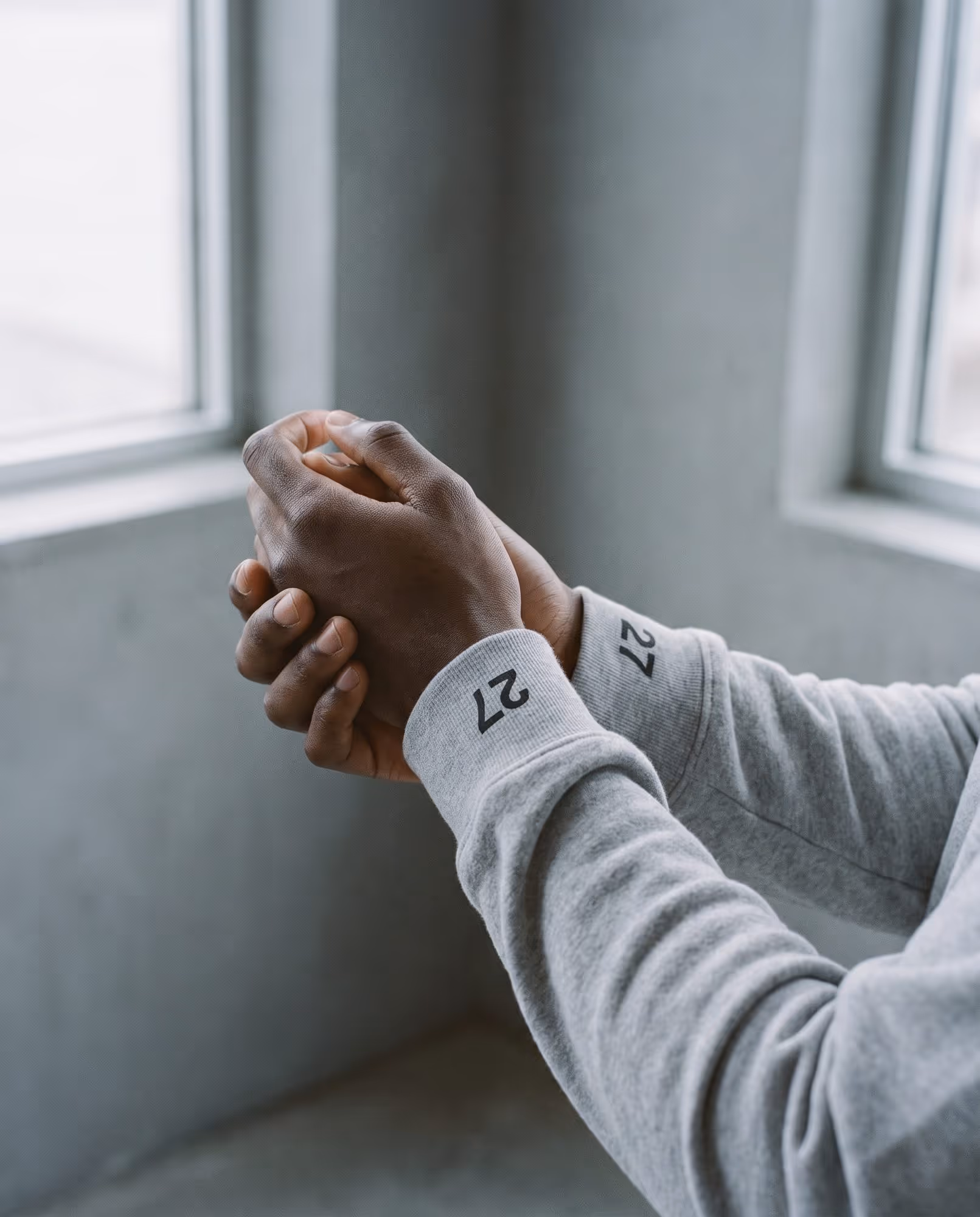 Heather grey crewneck cuffs with a small printed number 27 above each cuff