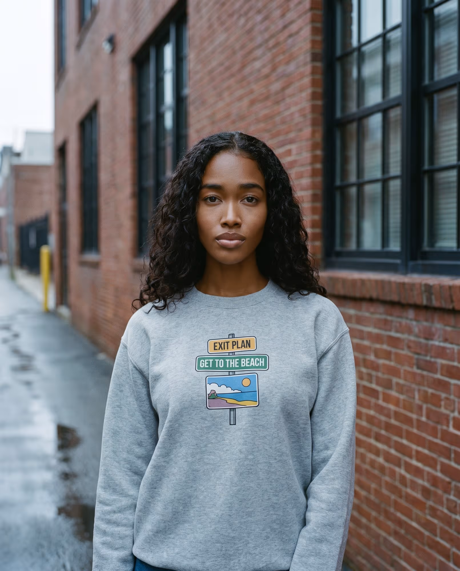 Heather grey crewneck sweatshirt with a printed beach road-sign chest graphic
