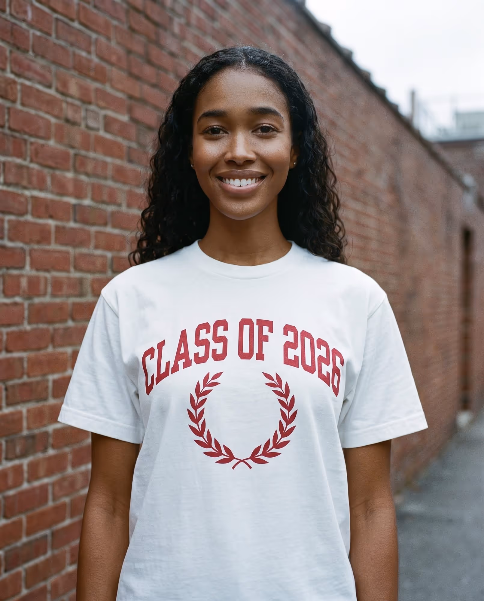 White t-shirt with "Class of 2026" printed in crimson above a laurel wreath
