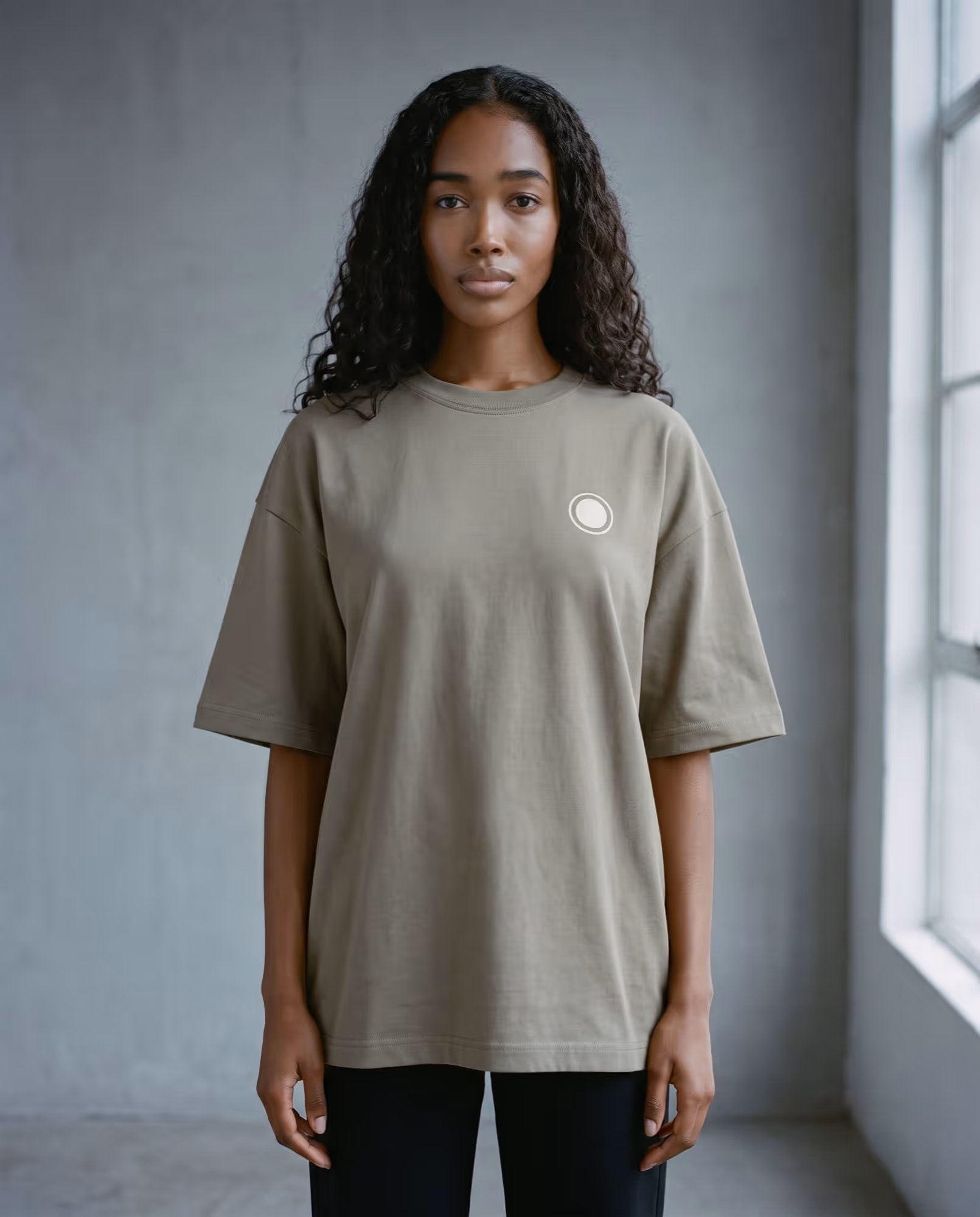 Sage oversized t-shirt with a small cream circle printed high on the left chest
