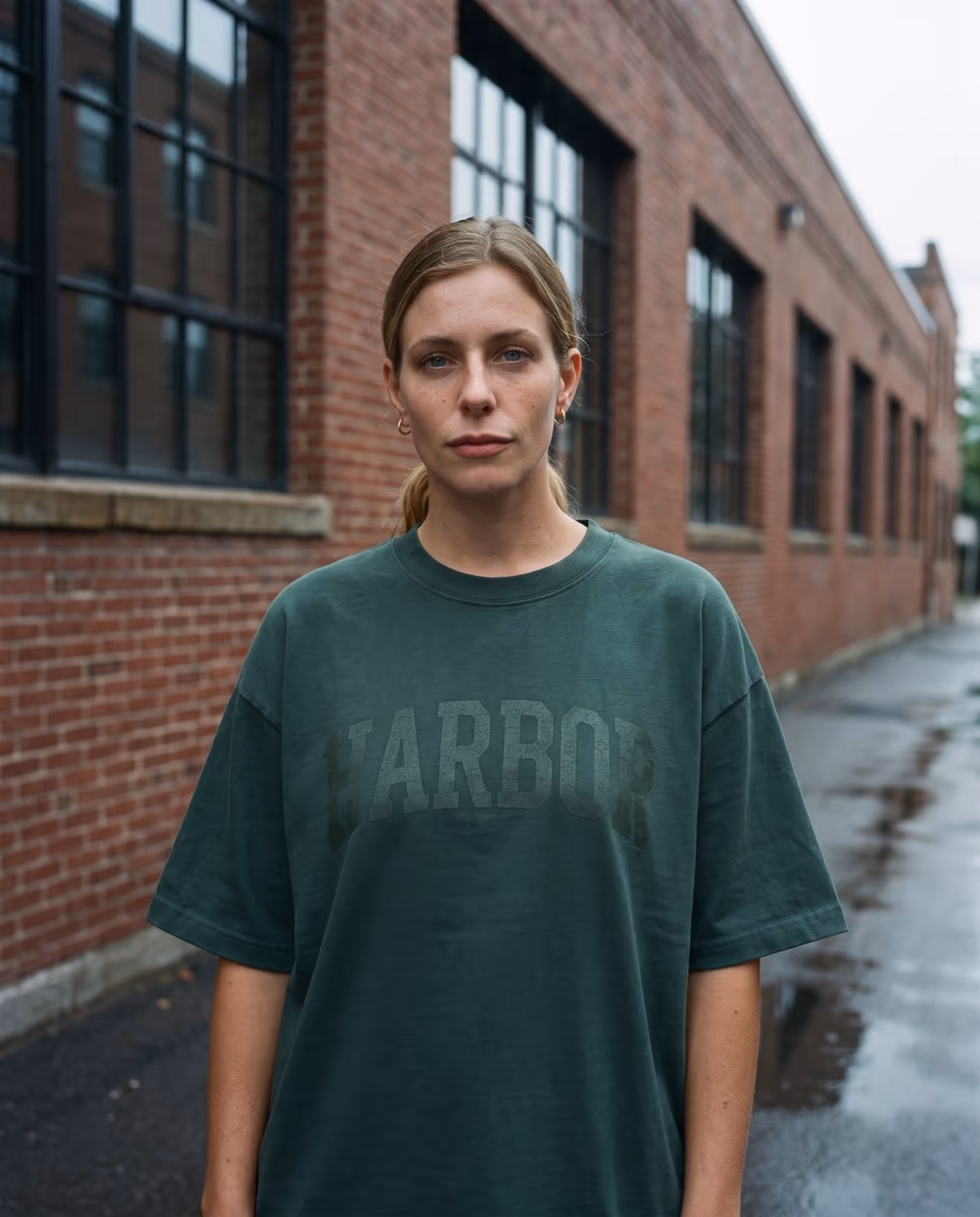 Pine green oversized t-shirt with HARBOR printed in the same green, readable only by its texture