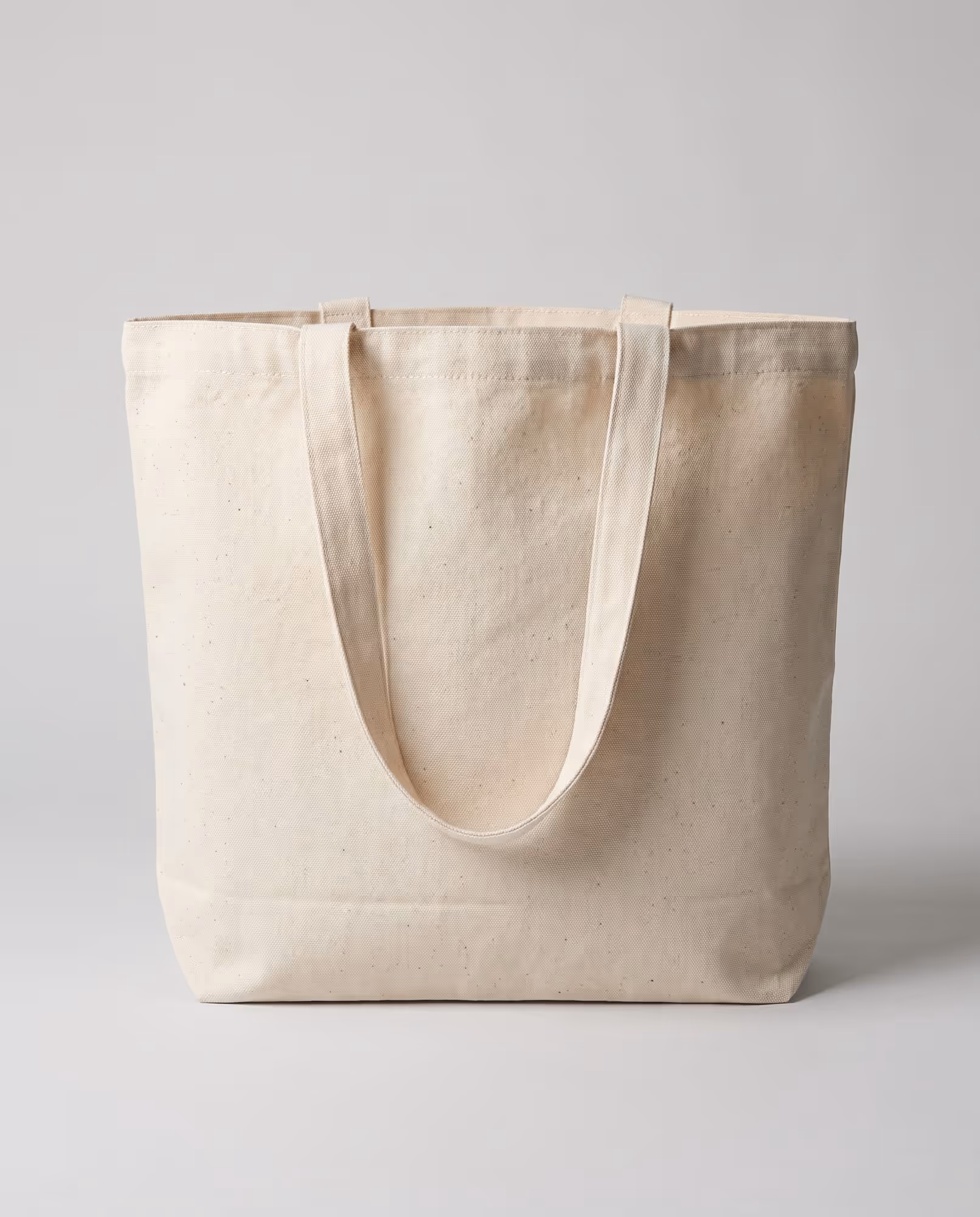 Plain natural cotton canvas tote bag blank standing upright, front view